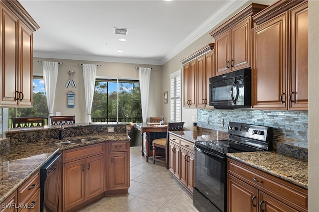 kitchen featuring light tile patterned flooring, sink, dark stone counters, black appliances, and crown molding