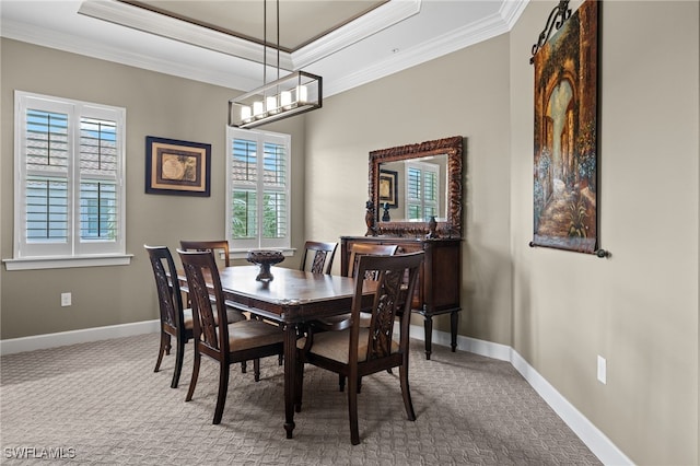 dining area with ornamental molding, a barn door, carpet floors, and a tray ceiling