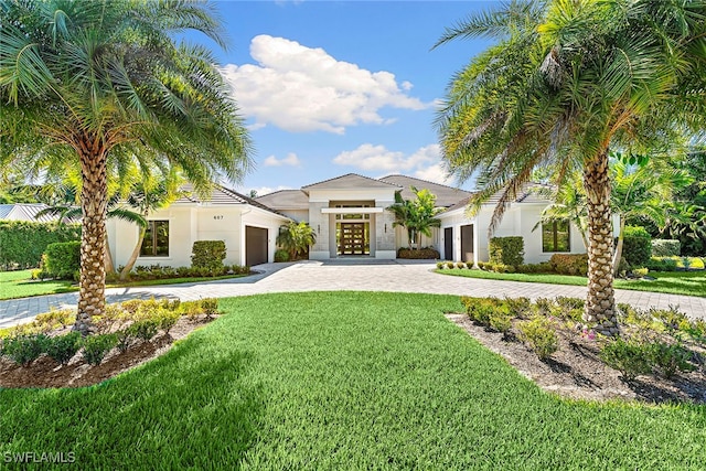 mediterranean / spanish-style house with french doors and a front lawn