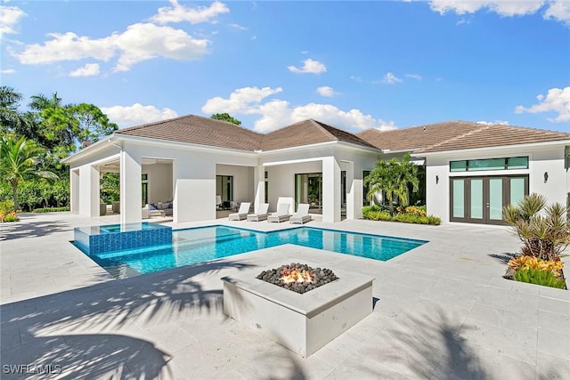 607 Myrtle Rd, Naples, FL 34108 - view of swimming pool with an outdoor living space with a fire pit, a patio, french doors, and a pool with connected hot tub