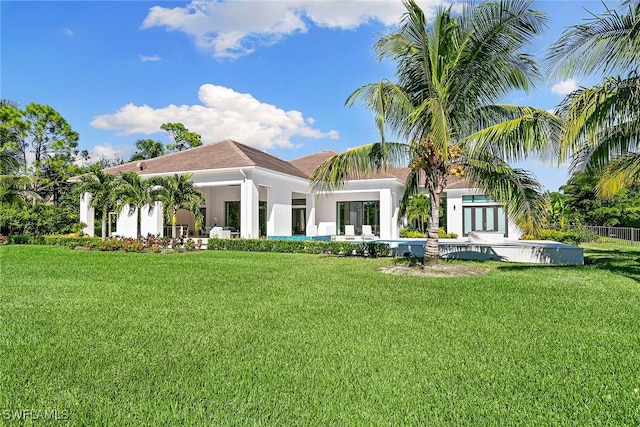 607 Myrtle Rd, Naples, FL 34108 - back of property featuring stucco siding and a lawn