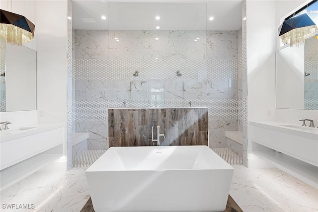 607 Myrtle Rd, Naples, FL 34108 - full bath with marble tiled floors, a freestanding tub, recessed lighting, and two vanities