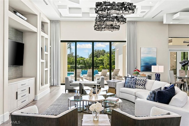 607 Myrtle Rd, Naples, FL 34108 - living area featuring coffered ceiling, a high ceiling, a chandelier, french doors, and wood finished floors