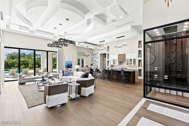 607 Myrtle Rd, Naples, FL 34108 - living room featuring a towering ceiling, coffered ceiling, light wood-type flooring, recessed lighting, and a chandelier