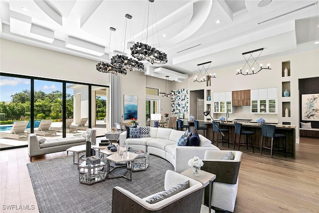 607 Myrtle Rd, Naples, FL 34108 - living room with a chandelier, a towering ceiling, coffered ceiling, light wood-type flooring, and recessed lighting