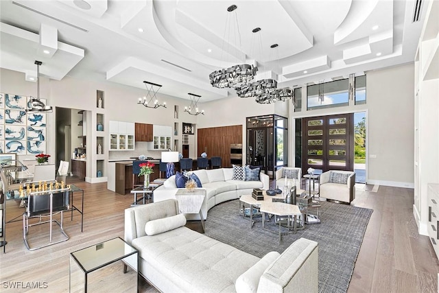 607 Myrtle Rd, Naples, FL 34108 - living room featuring a towering ceiling, a chandelier, light wood-type flooring, and recessed lighting