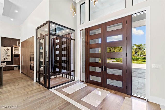607 Myrtle Rd, Naples, FL 34108 - entrance foyer with light wood-style floors, french doors, a towering ceiling, recessed lighting, and baseboards