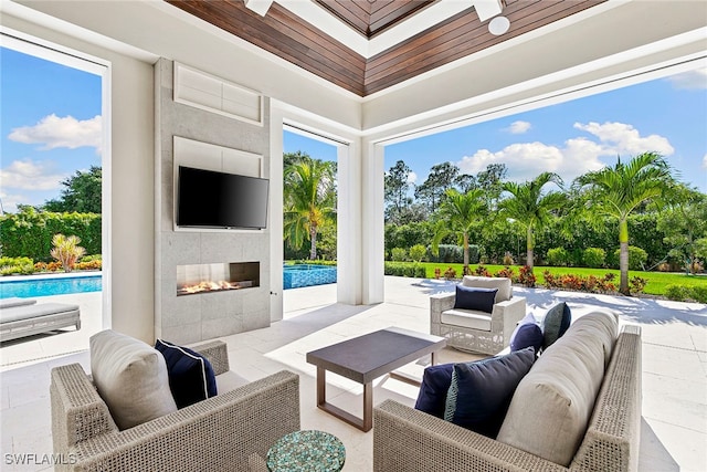 view of patio featuring an outdoor living space with a fireplace