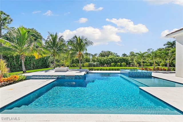 view of swimming pool featuring a patio area and an in ground hot tub