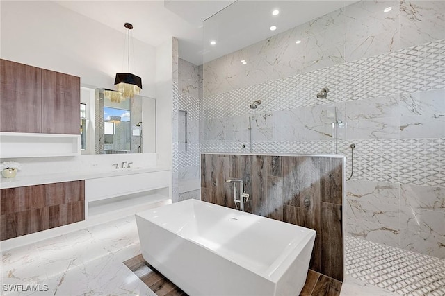 607 Myrtle Rd, Naples, FL 34108 - full bathroom with a soaking tub, walk in shower, vanity, marble finish floors, and recessed lighting