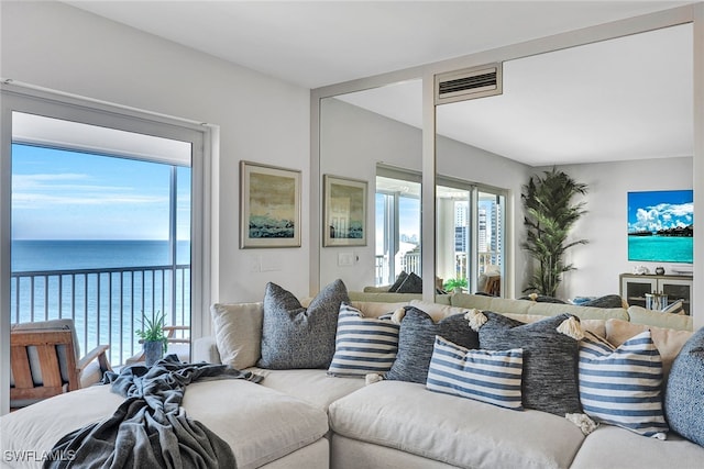 living room featuring a water view and a wealth of natural light