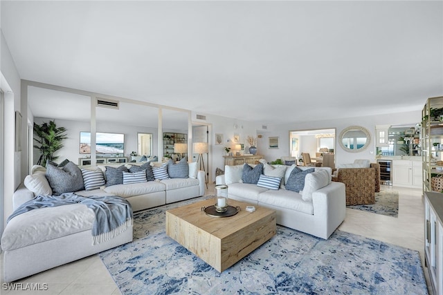 tiled living room featuring wine cooler and plenty of natural light