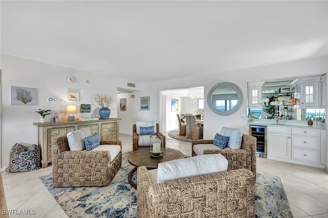 tiled living room featuring beverage cooler and indoor bar