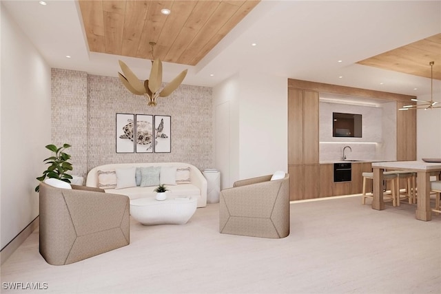 living room featuring wood walls, sink, wood ceiling, and an inviting chandelier