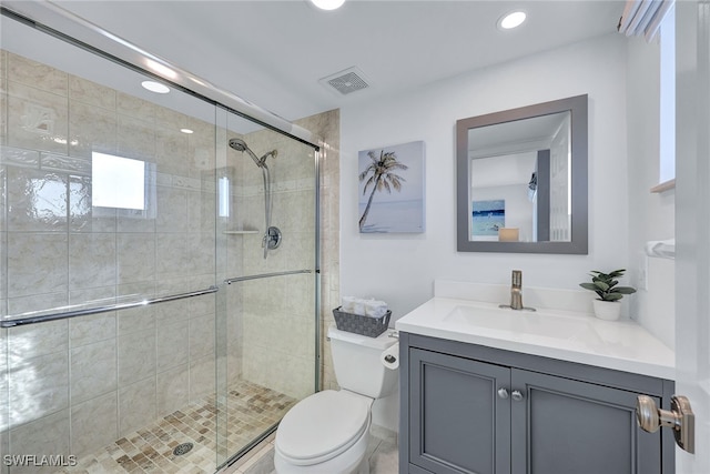 bathroom with vanity, toilet, and an enclosed shower