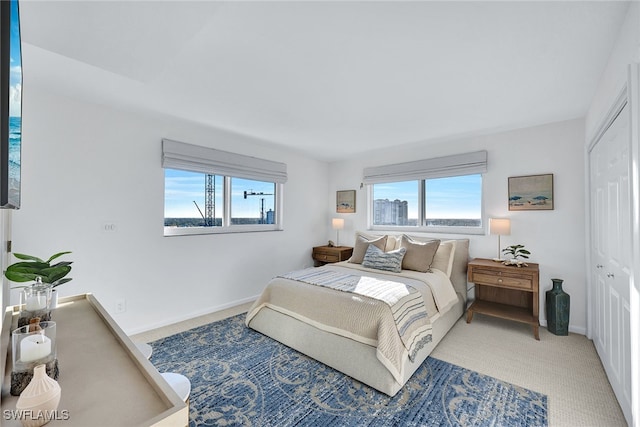 carpeted bedroom with multiple windows and a closet