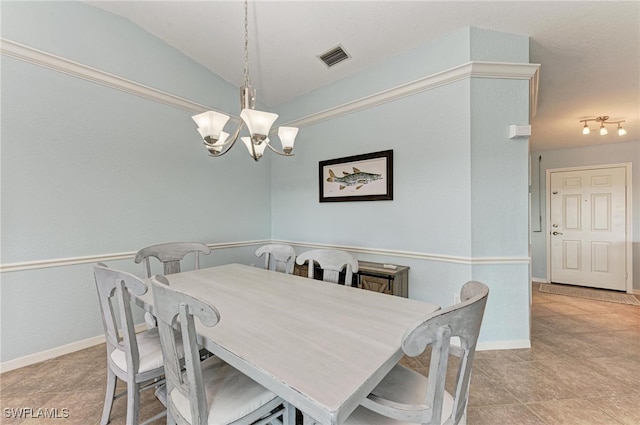 tiled dining space featuring a notable chandelier