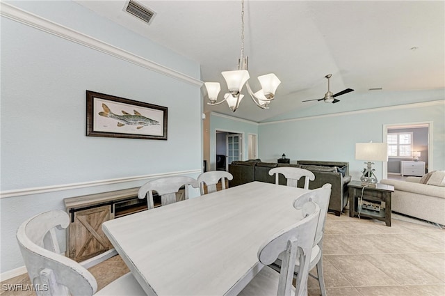 dining space with light tile patterned floors, ceiling fan with notable chandelier, and vaulted ceiling