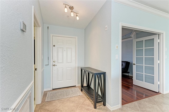 interior space with ornamental molding and light hardwood / wood-style flooring