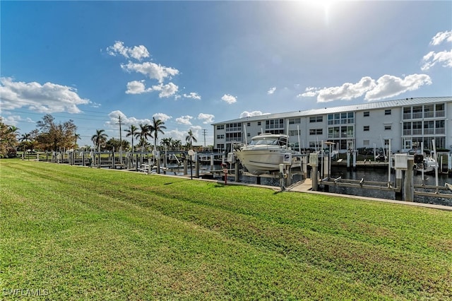 view of dock featuring a water view and a yard