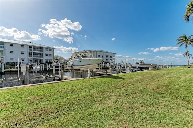 dock area with a water view and a lawn