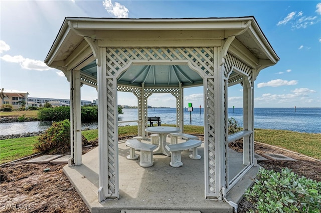 view of patio featuring a gazebo and a water view