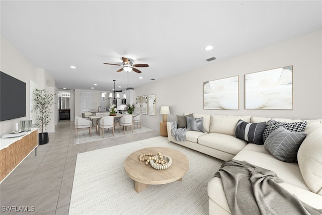 tiled living room with ceiling fan