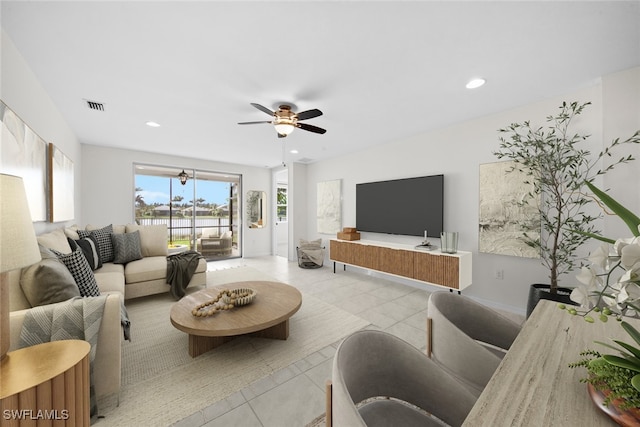 living room with ceiling fan and light tile patterned flooring