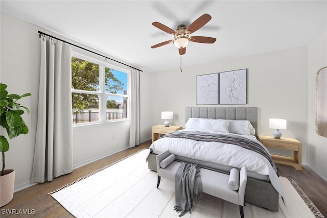 bedroom with ceiling fan and hardwood / wood-style floors