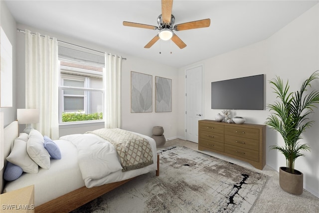 bedroom featuring ceiling fan and light carpet