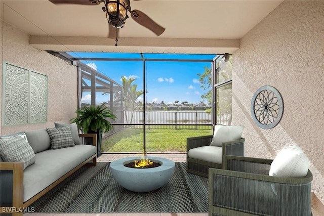 sunroom / solarium featuring ceiling fan