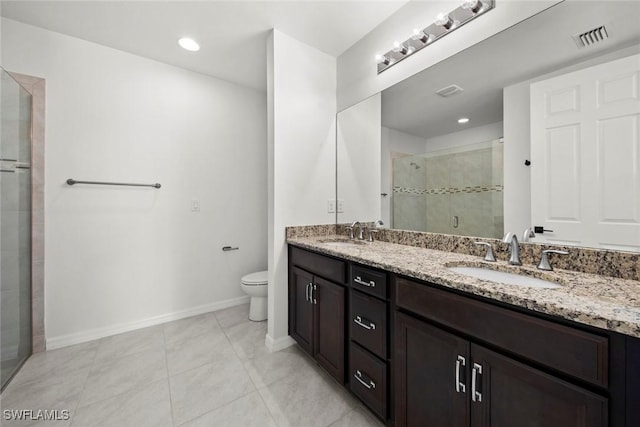 bathroom with tile patterned flooring, vanity, toilet, and a shower with shower door