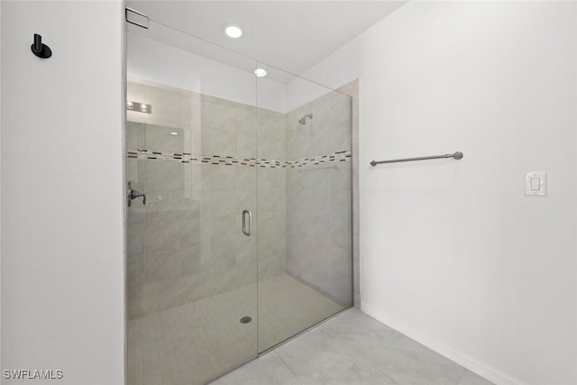 bathroom with tile patterned floors and walk in shower