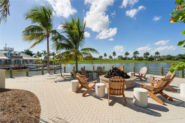 view of patio / terrace featuring a water view and an outdoor fire pit