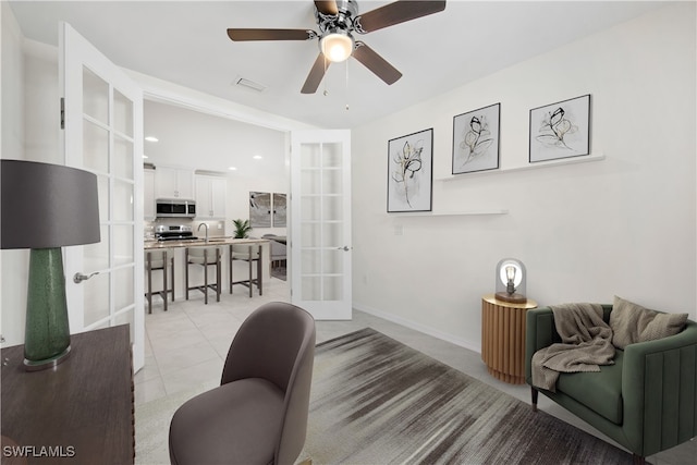 office space featuring ceiling fan, light tile patterned floors, and french doors