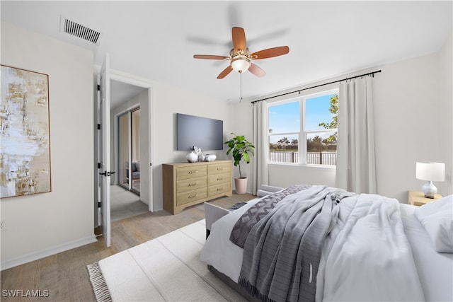 bedroom with light hardwood / wood-style flooring and ceiling fan