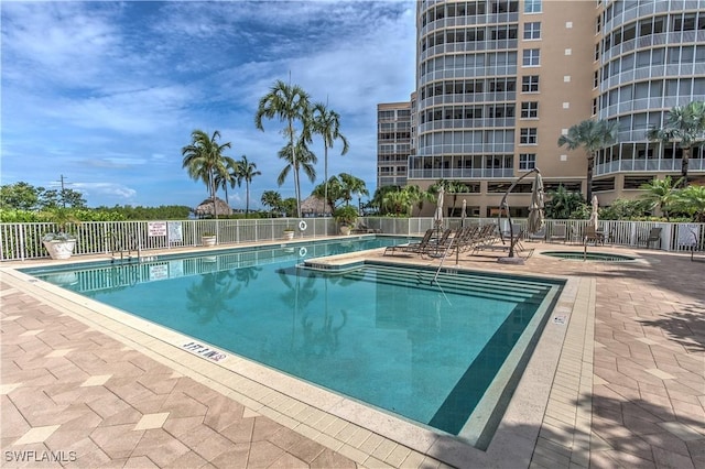 view of pool featuring a community hot tub and a patio area