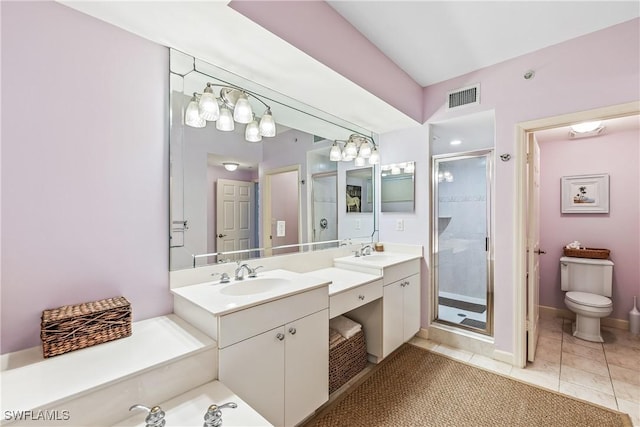 bathroom with tile patterned floors, toilet, a shower with door, and vanity