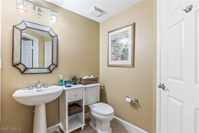 bathroom with tile patterned flooring, sink, and toilet