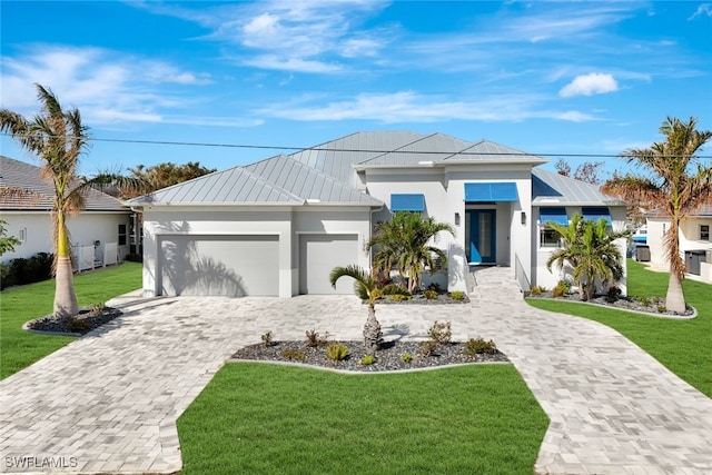 view of front of property featuring a garage and a front lawn