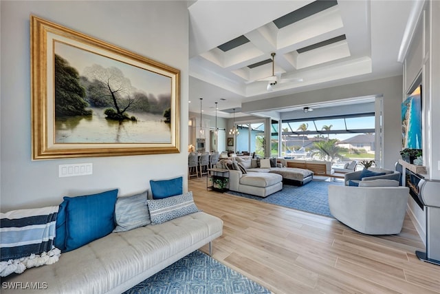 living room with light hardwood / wood-style flooring, beamed ceiling, and coffered ceiling