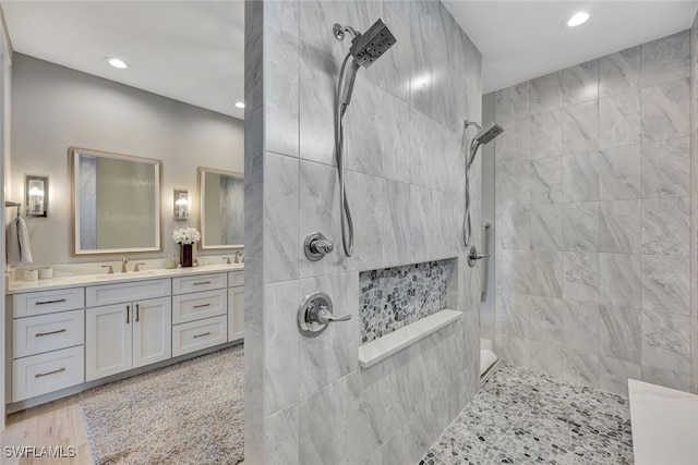 bathroom with vanity and tiled shower