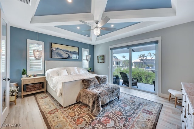 bedroom with ceiling fan, access to exterior, light wood-type flooring, and multiple windows