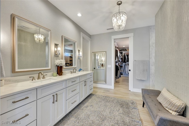 bathroom with hardwood / wood-style floors, vanity, and tile walls