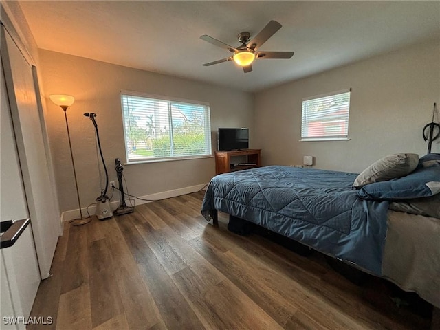 bedroom with ceiling fan and dark wood-type flooring