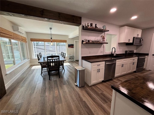 kitchen with appliances with stainless steel finishes, decorative backsplash, white cabinets, and sink