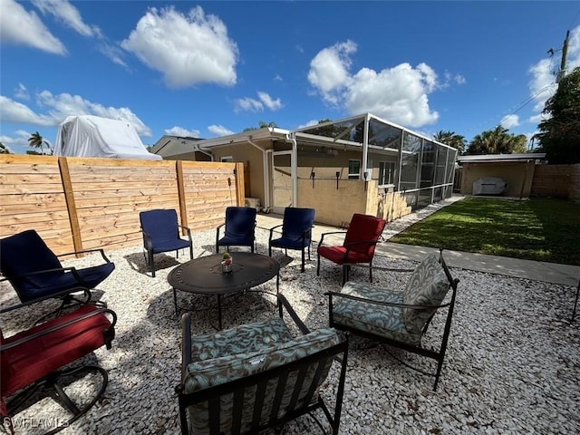 view of patio / terrace featuring glass enclosure