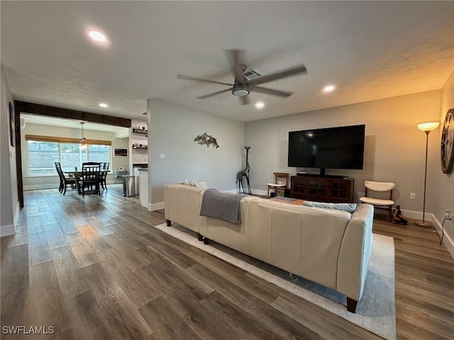 living room with ceiling fan and dark hardwood / wood-style floors