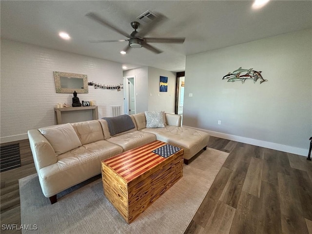 living room featuring ceiling fan and hardwood / wood-style floors