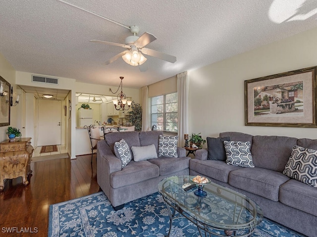 living room with a textured ceiling, ceiling fan with notable chandelier, and hardwood / wood-style floors